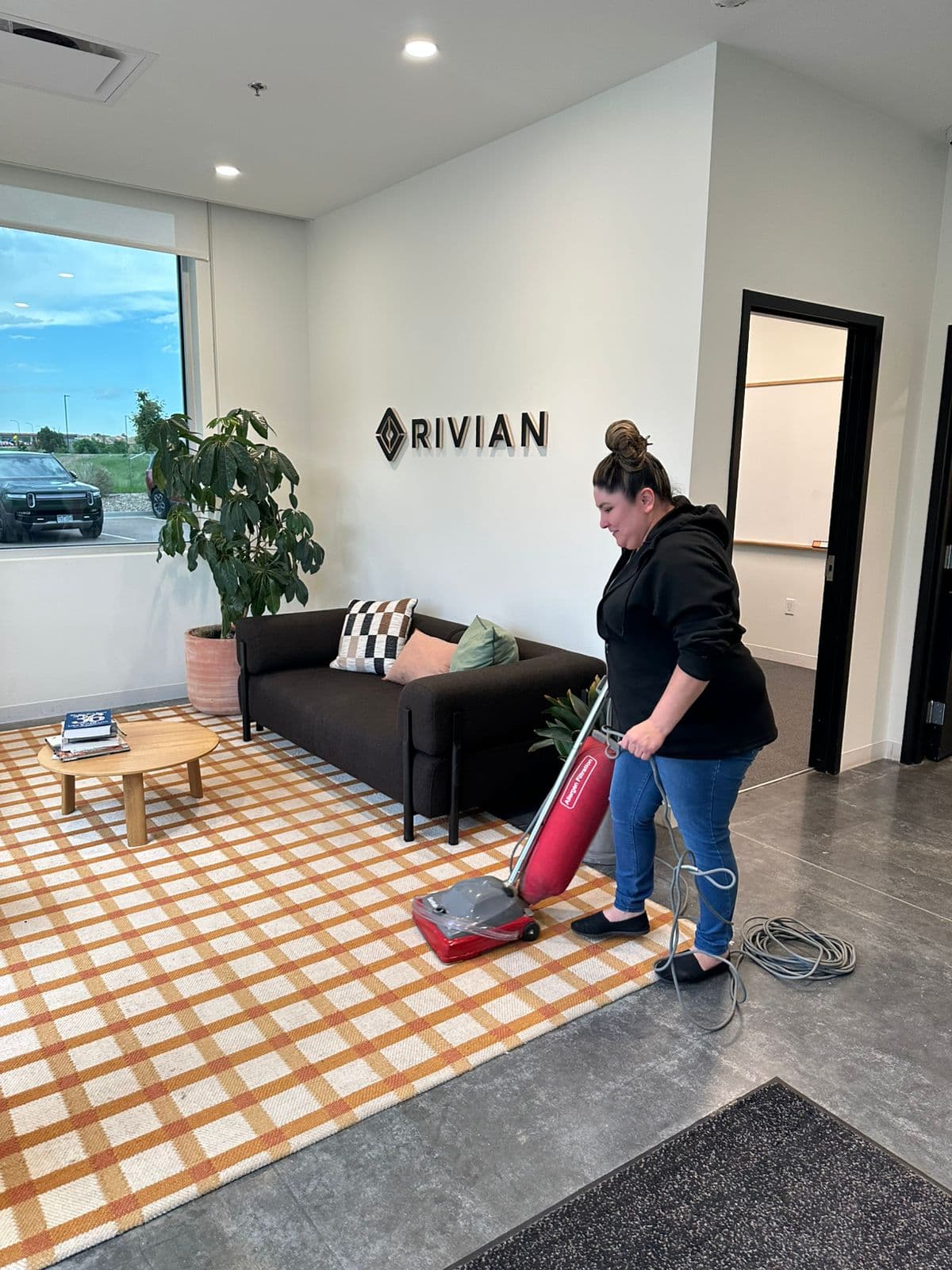 Kathy Clean technician vacuuming the lobby of a Rivian office in the Denver metro area