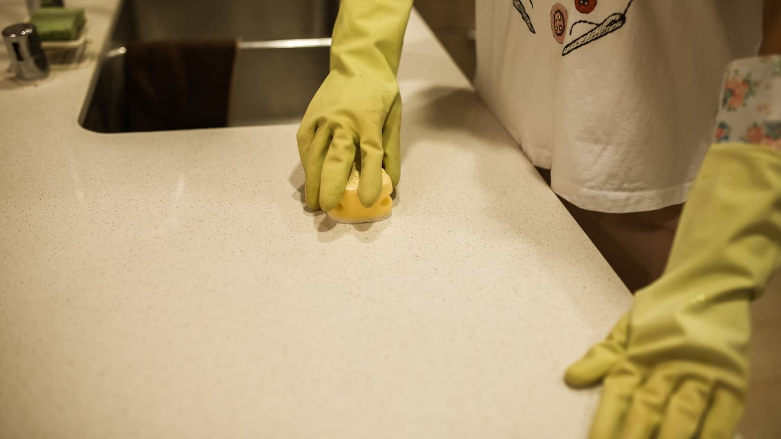 Person deep cleaning a kitchen counter