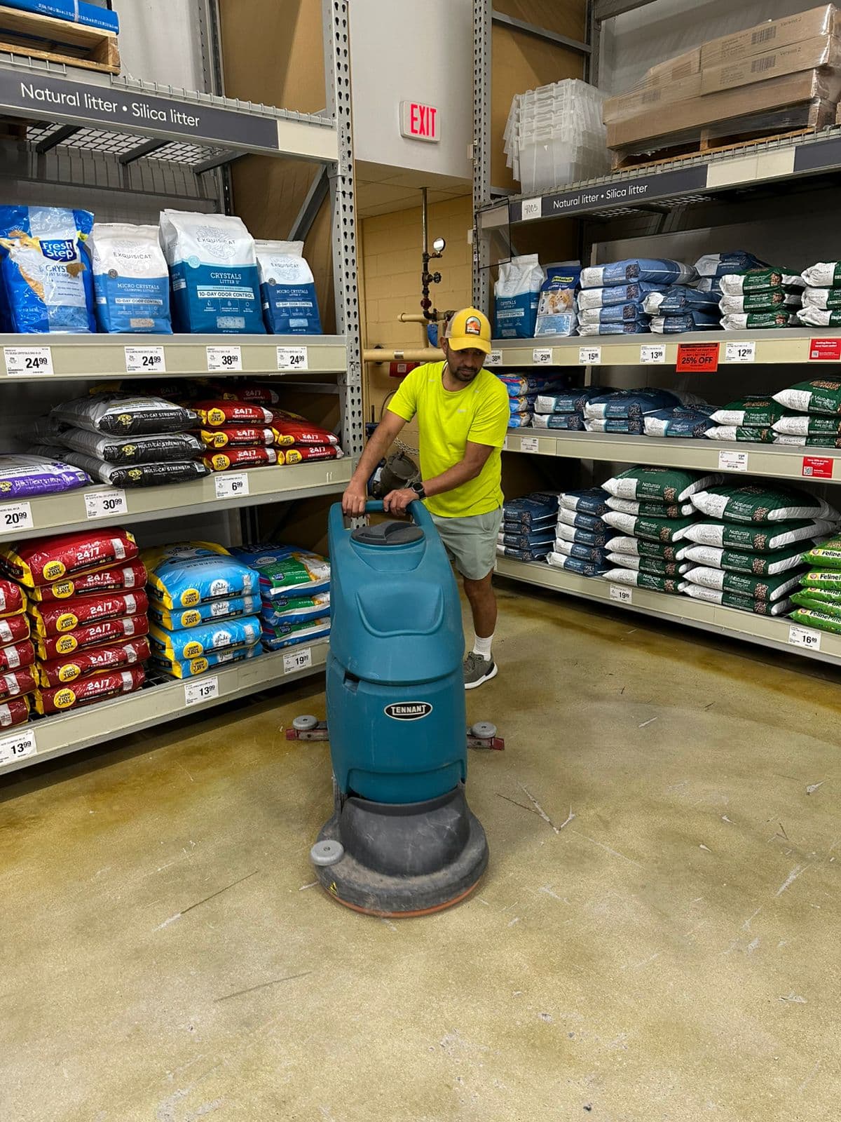 Kathy Clean technician operating a Tennant floor scrubber in a Glendale retail aisle