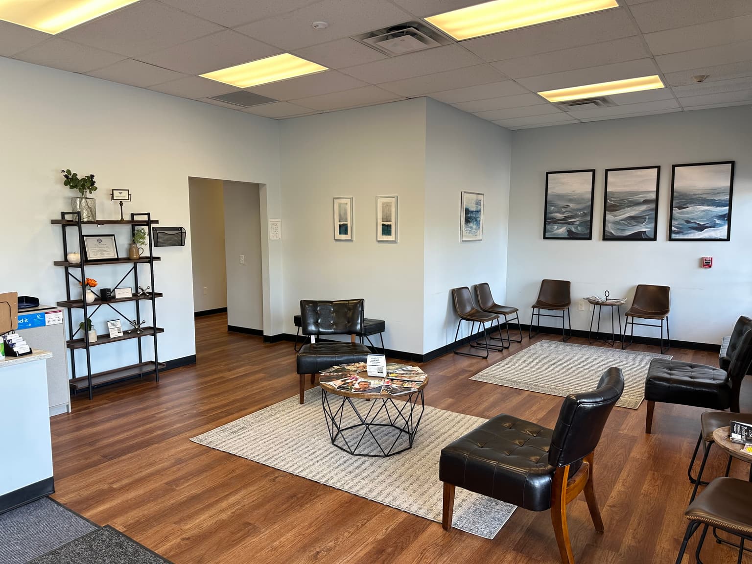 Clean Aurora medical office waiting room with leather seating and warm wood flooring